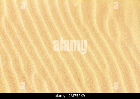 Rippled sand on the sea coast formed by wind and water, background, texture, pattern, banner Stock Photo