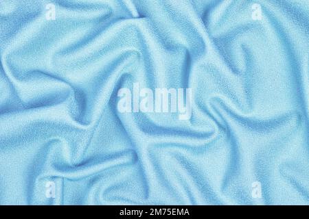 Sky blue woolen crumpled wrinkled fabric with waves, background crumpled tissue Stock Photo