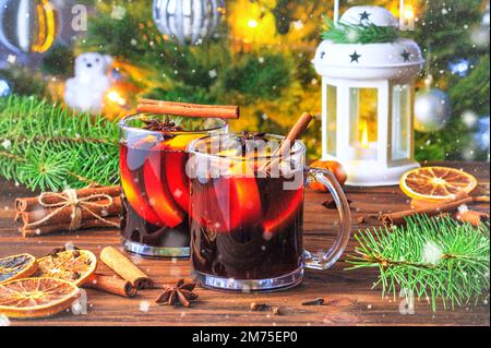Christmas mulled red wine glühwine with aromatic spices and citrus fruits on a wooden rustic table. Traditional hot drink or festive cocktail at Chris Stock Photo
