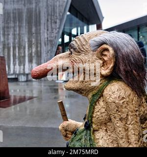 Troll with long nose laughs, sculpture standing in the rain, visitor centre at Trollstigen, Norway Stock Photo