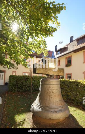 Bell in the courtyard of the monastery church of the Assumption of the Virgin Mary in the backlight in St. Maergen, Southern Black Forest, Black Stock Photo