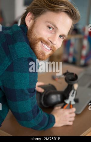 young repairman fixing and repairing microwave oven Stock Photo