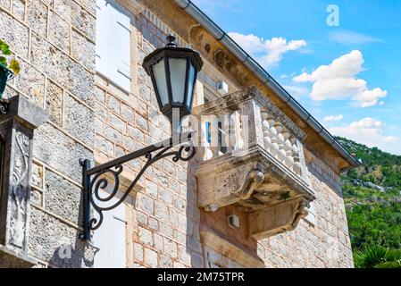 Retro lantern near balcony on old house in Perast, Montenegro Stock Photo