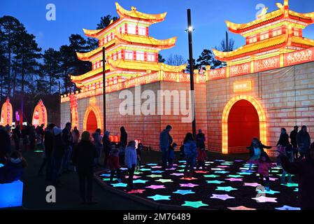 Children interact with lights outside the Dragon Palace as darkness falls on the Chinese Lantern Festival in Cary, North Carolina. Stock Photo