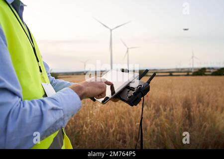 Operator holding remote control operating drone using remote controller Engineer playing with drone Stock Photo