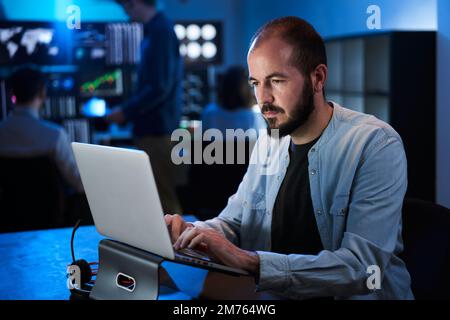 Financial Analyst Working on a Computer with Multi-Monitor Workstation Stocks, Commodities and Exchange Market Charts. Businessman Works in Investment Stock Photo