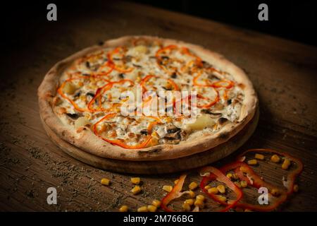 delicious pizza with mushroom, pineapple, corn and sweet pepper paprica Stock Photo