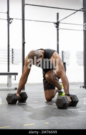 African American adult male doing intense exercise at the gym. Space for text. Stock Photo