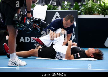 Adelaide, Australia, 7 January, 2023. Yoshihito Nishioka of Japan receives physio attention in medical time out before retiring injured during the Adelaide International tennis match between Sebastian Korda of United States and Yoshihito Nishioka of Japan at Memorial Drive on January 07, 2023 in Adelaide, Australia. Credit: Peter Mundy/Speed Media/Alamy Live News Stock Photo