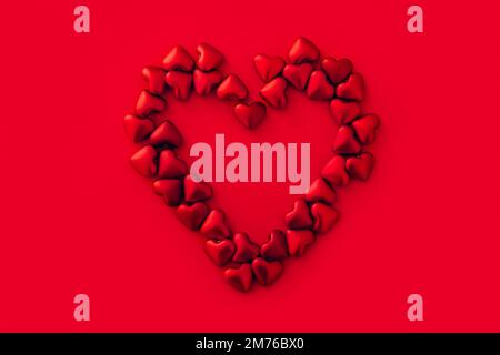 Valentine's day. Big heart made from many small red hearts on red background, love concept Stock Photo