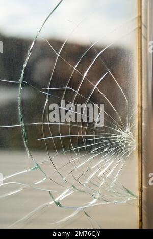 Dirty broken window glass with cracks from stone hit or beak from bird flying near creation Stock Photo
