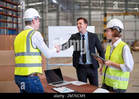 manager visit staff in storage warehouse and have some discussion with site team appreciated and congratulation check hand Stock Photo