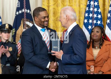 Washington, United States Of America. 06th Jan, 2023. Washington, United States of America. 06 January, 2023. U.S President Joe Biden awards the Presidential Citizens Medal to Capitol Police Officer Eugene Goodman, left, for his role defending the Capitol during a ceremony at the East Room of the White House, January 6, 2023 in Washington, DC The ceremony marked the two-year anniversary of the January 6th insurrection. Credit: Adam Schultz/White House Photo/Alamy Live News Stock Photo