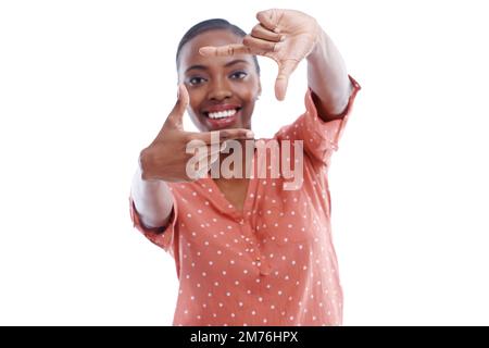 Do you want to be in a movie. an attractive young woman using her hands to find a view. Stock Photo