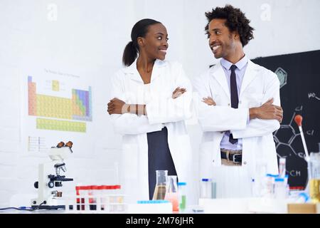 Lab partners bonding. two scientists standing together in their lab. Stock Photo