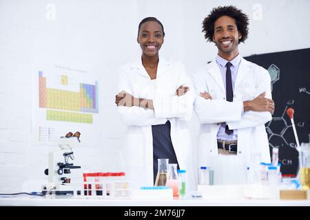 No mad scientists here. Portrait of two scientists standing together in their lab. Stock Photo