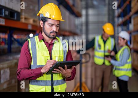 Worker in warehouse holding check list tablet pc stand portrait photo Stock Photo