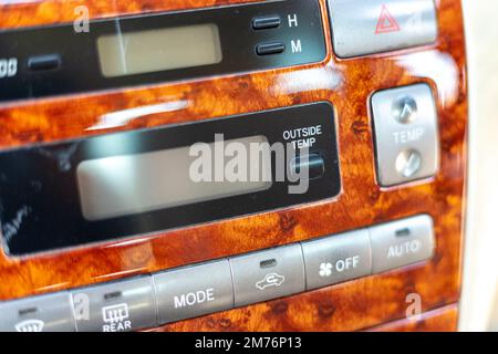 Closeup of a outside temperature button on a car's dashboard Stock Photo