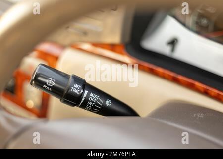 Wipers control of a vehicle with adjusting speed of screen wipers in the vehicle. Stock Photo