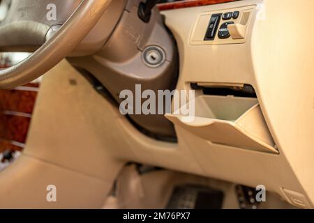 Small storage compartment below steering wheel Stock Photo