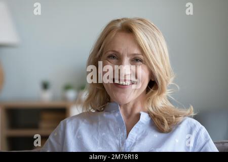 Happy positive senior pretty woman home head shot portrait Stock Photo