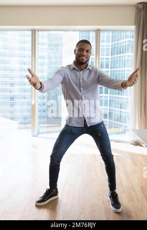 African man moving to music looks at camera Stock Photo