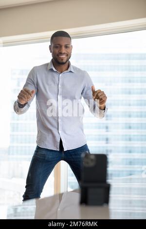 African man record dance on smart phone camera Stock Photo