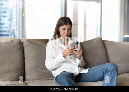 Woman spend weekend on internet using modern smart phone Stock Photo