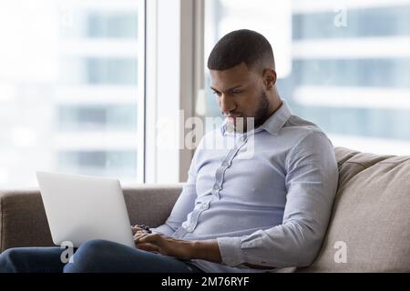 African man working or studying using laptop Stock Photo