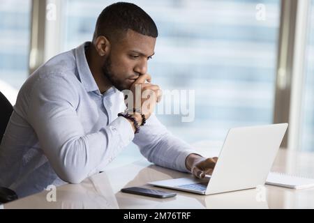African businessman learns new software, working on project use laptop Stock Photo
