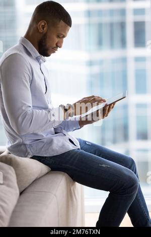 African businessman working on on-line project using digital tablet Stock Photo