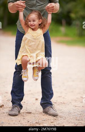 Shell always be my baby girl. A little girl being playfully lifted into the air by her dad. Stock Photo