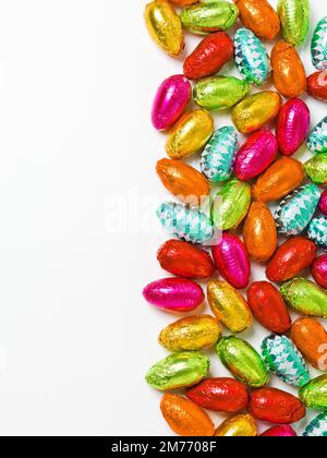 This is what it would look like if rain was chocolate. Studio shot of a dazzling array of multicolored easter eggs wrapped in foil. Stock Photo