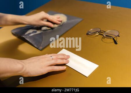 Female hands touches exposition in museum. Convex exhibit for visually impaired and blind people. Braille and accessibility for disabilities people. T Stock Photo
