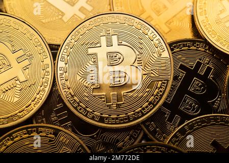 Golden coins with bitcoin symbol close up. Bitcoin and cryptocurrency investing concept. Bitcoin cryptocurrency coins. Trading on the cryptocurrency Stock Photo