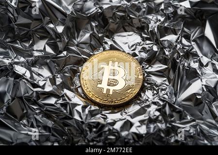 Golden coin with bitcoin symbol close up. Bitcoin and cryptocurrency investing concept. Bitcoin cryptocurrency coin. Trading on the cryptocurrency exc Stock Photo