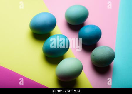Happy Easter pastel coloured background. Hand painted Easter eggs abstract minimal concept. Stock Photo