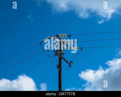 Close up of  high-voltage insulating support of a transmission line pylon. Danger of electric shock, insulation of wires and cables under voltage. Stock Photo