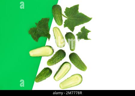 Cucumber salad vegetable health food freshly grown organic local produce c with leaves on dual green white background. Eco friendly concept. Stock Photo