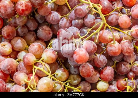 Bunch of red grapes on a supermarket shelf. background. close-up Stock Photo