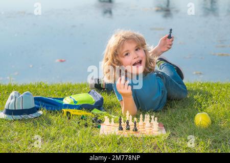 Clever concentrated and thinking child playing chess. Stock Photo