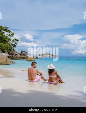 Couple on the beach at the tropical Similan Islands in Southern Thailand. Men and women on the beach of Similan. Stock Photo