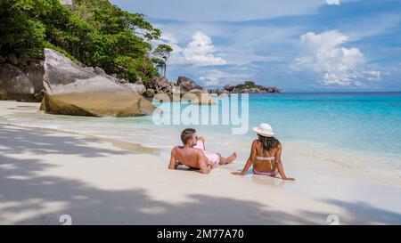 Couple on the beach at the tropical Similan Islands in Southern Thailand. Men and women on the beach of Similan. Stock Photo