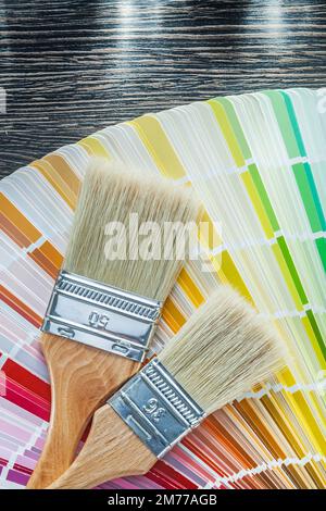 Color pantone fan paint brushes on wooden board top view. Stock Photo