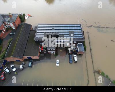 Hereford, Herefordshire, UK – Sunday 8th January 2023 – UK Weather – Aerial view of flooding along the River Wye as it passes through Hereford has resulted in the local rowing club being surrounded by flood water. At 10am the River Wye was at 4.52m and rising as it flows through Hereford. More rain is forecast. Photo Steven May / Alamy Live News Stock Photo