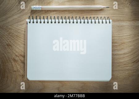 Opened notepad pencil on wooden board. Stock Photo