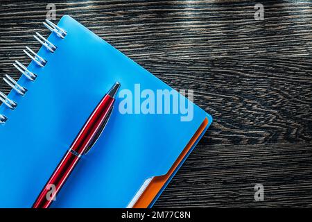 Pen spiral notebook on vintage wooden board. Stock Photo