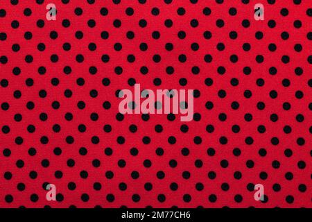 Pink polka-dot cotton fabric directly above. Stock Photo