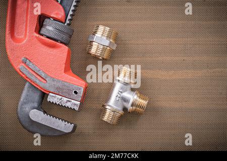 Pipe wrench plumbing fixtures on mesh filter grid Stock Photo - Alamy