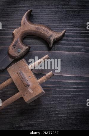 Rough rusted hand saw vintage wooden marking gage. Stock Photo